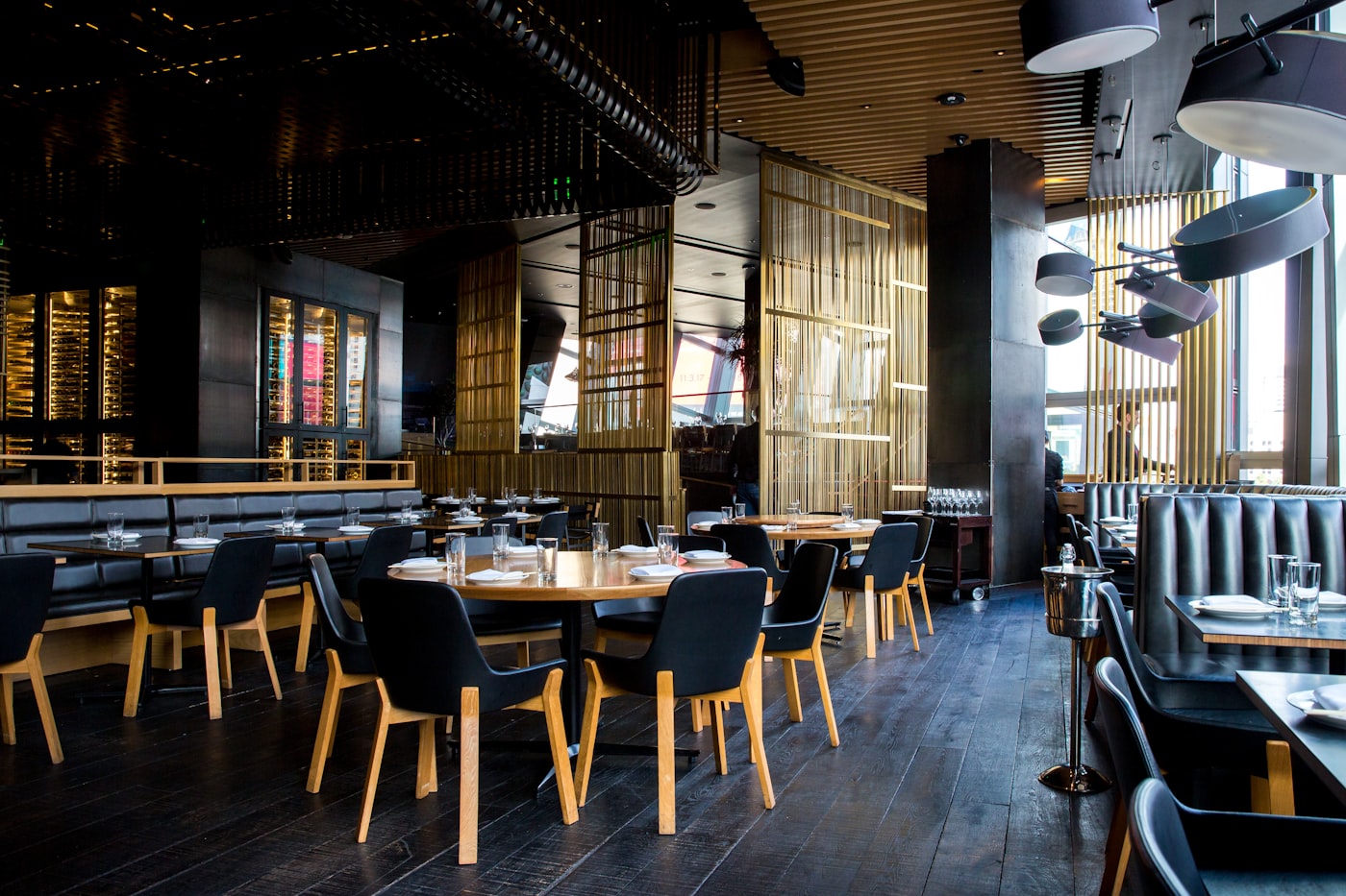 Quiet fine-dining room with soft light and set tables
